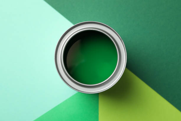 istock Can of green paint on multicolored background, top view 1209108215