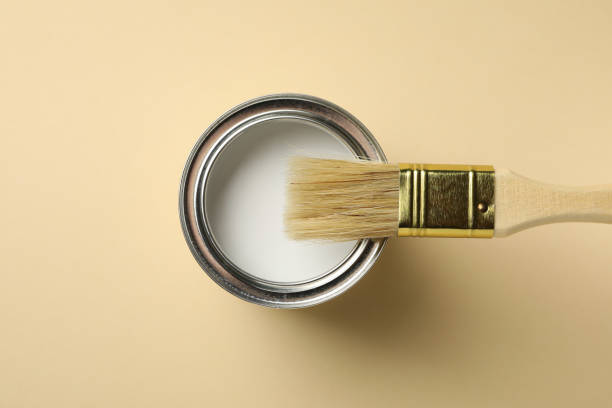 istock Paint can and brush on beige background, top view 1209108252