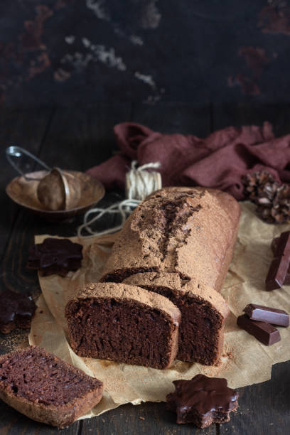 istock Delicious dark chocolate cake on paper on dark wooden background. Selective focus. Copy space. 1209108365