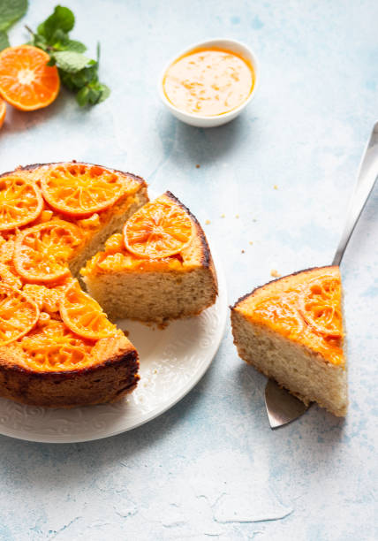 istock Upside down tangerine cake on a sky-blue stone background. 1209108375