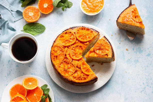 istock Upside down tangerine cake on a sky-blue stone background. 1209108507