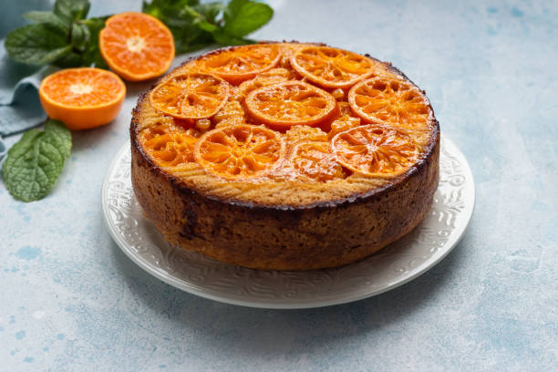 istock Upside down tangerine cake on a sky-blue stone background. 1209108531