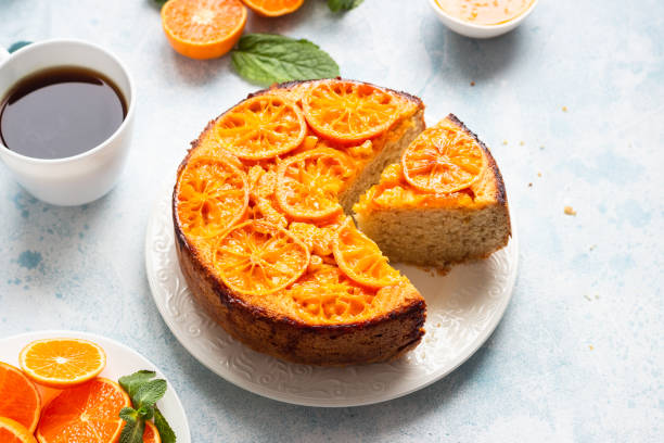 istock Upside down tangerine cake on a sky-blue stone background. 1209108547