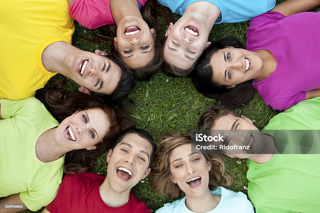 Happy united friends Happy joyful group of young friends enjoy together the life outdoor. Circle Stock Photo