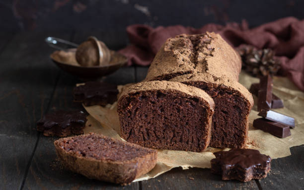 istock Delicious dark chocolate cake on paper on dark wooden background. Selective focus. Copy space. 1209109390