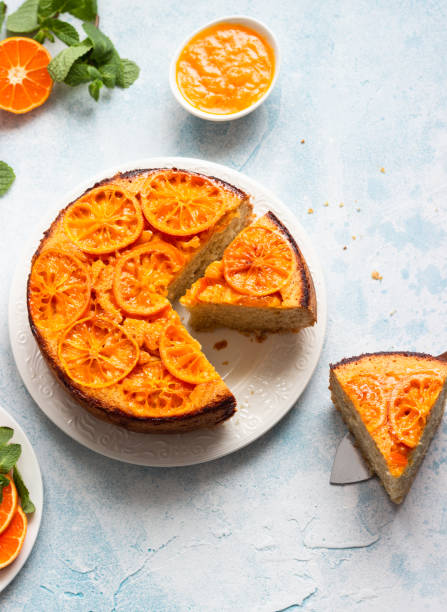 istock Upside down tangerine cake on a sky-blue stone background. 1209109507