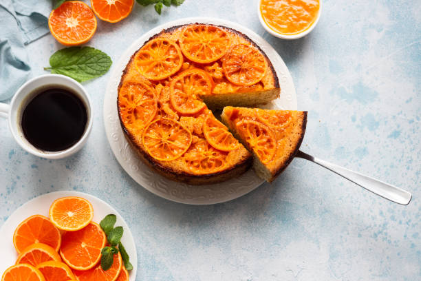 istock Upside down tangerine cake on a sky-blue stone background. 1209109589