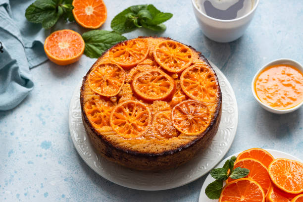 istock Upside down tangerine cake on a sky-blue stone background. 1209109705