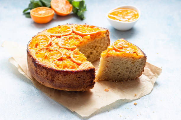 istock Upside down tangerine cake on a sky-blue stone background. 1209109721