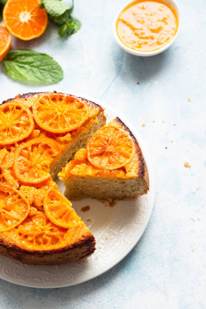 istock Upside down tangerine cake on a sky-blue stone background. 1209109750