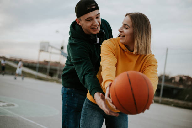 istock Happy couple is playing basketball 1209111206