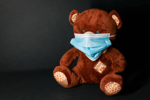 Teddy bear with protective mask stock photo
