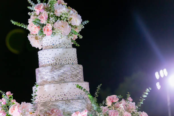 istock cake for wedding party. Beautiful wedding reception.Look from afar at luxurious restaurant hall prepared for wedding dinner. 1209113716