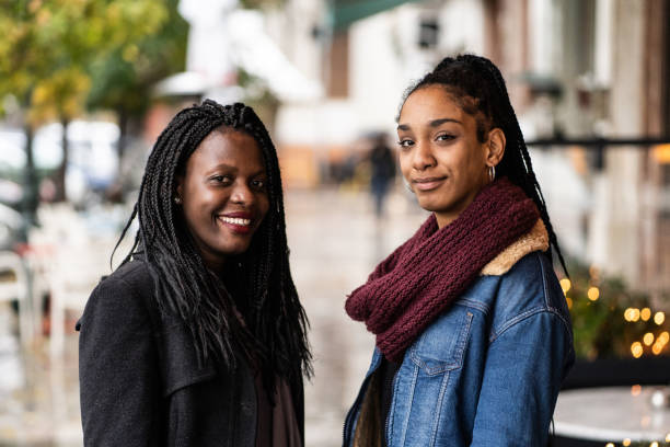 istock Female friends walking on sidewalk and talking 1209116094