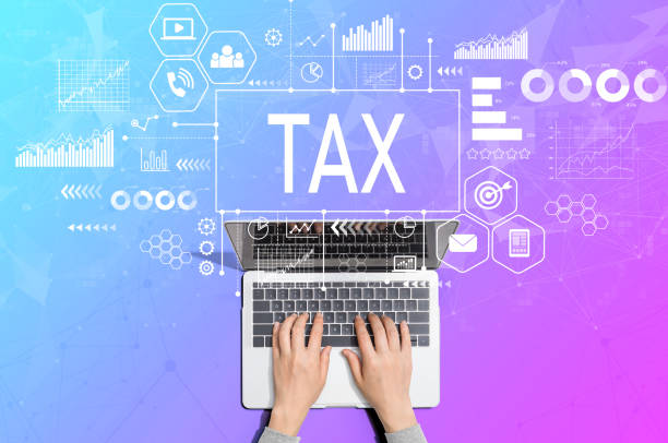 istock Tax theme with person using laptop 1209116176