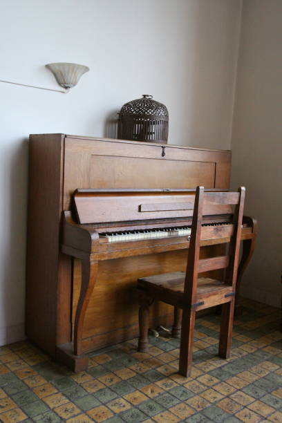istock An antique organ with chair on an old tile floor. 1209117351