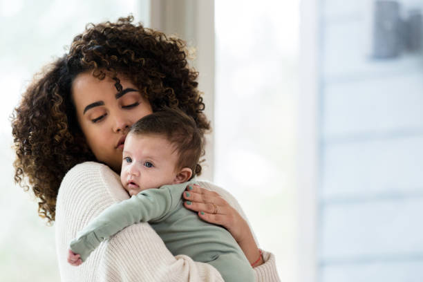 istock Adorable baby boy is held by his mom 1209117954