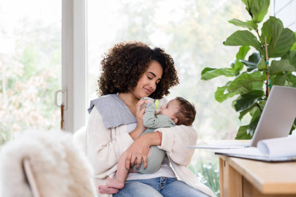 istock Mom feeds baby a bottle 1209118016