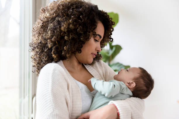 istock Adorable baby looking at his mother 1209118021