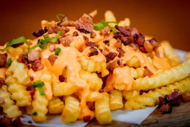 French Fries French fries, bacon and cheddar cheese on top. cheddar cheese photos stock pictures, royalty-free photos & images
