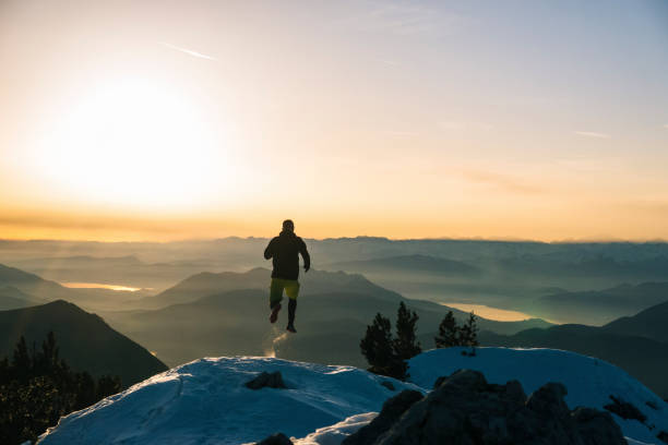 istock Trail runner ascends snowy mountain ridge crest at dawn 1209120307