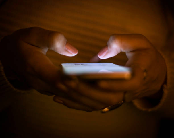 istock Woman texting in the dark 1209120460