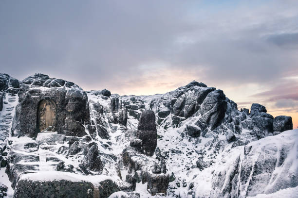 Nossa Senhora da Boa Estrela, a religious sculpture carved in the rock near the top of Serra da Estrela (Portugal), photographed in the winter at suns