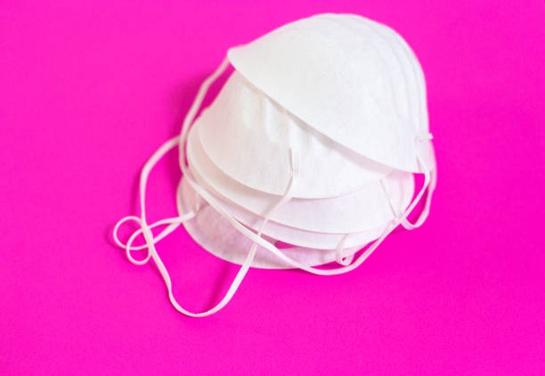 istock Pile of Face/Surgical Masks, Pink Background 1209125552