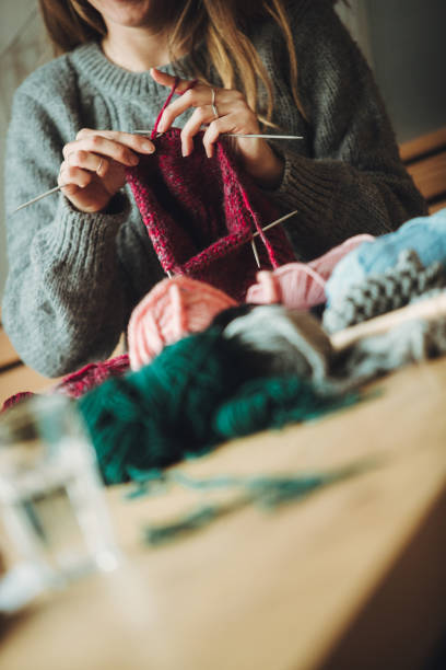 istock Close up on woman's hands knitting 1209128582