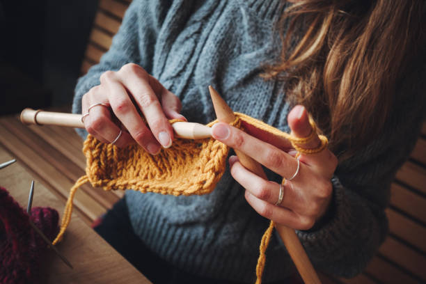 istock Close up on woman's hands knitting 1209128585