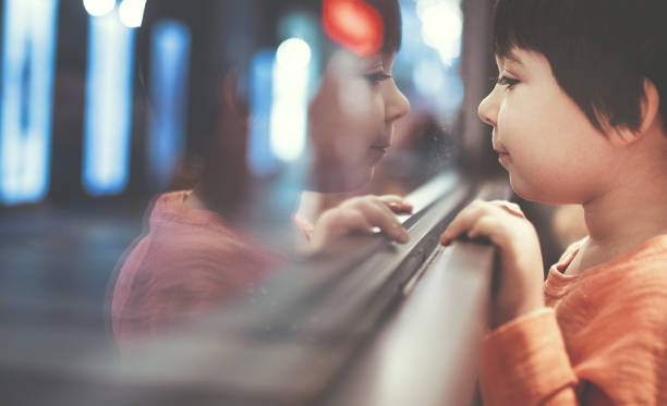 istock Little boy looking out of the window 1209136801