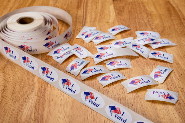 istock Looking down on a roll of “I Voted” stickers with some torn off on a table 1209137079