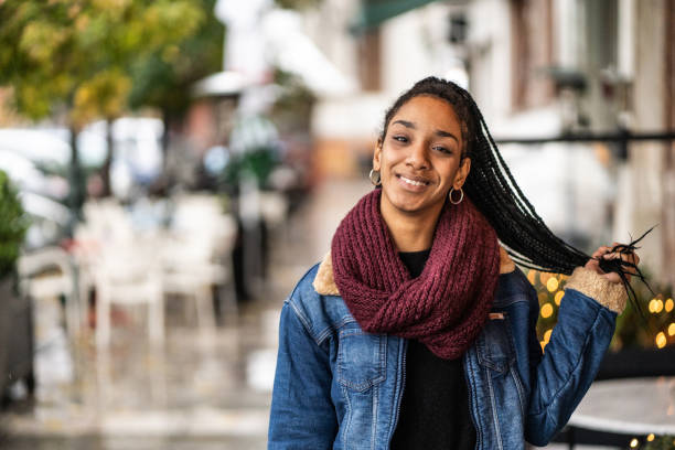 istock Young woman posing on sidewalk 1209137163