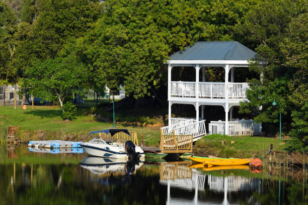 istock Riverside Pavilion With Motorboat And Kayaks 1209139146