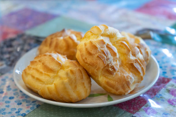 istock eclairs in white ceramic plate on table in cafe 1209140366