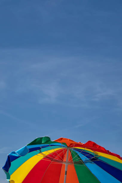 istock Colorful beach umbrella under the sun 1209141019