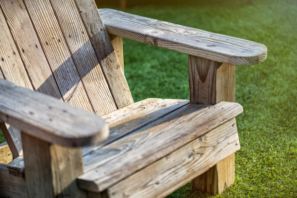 Old, wooden lawn chair on the grass