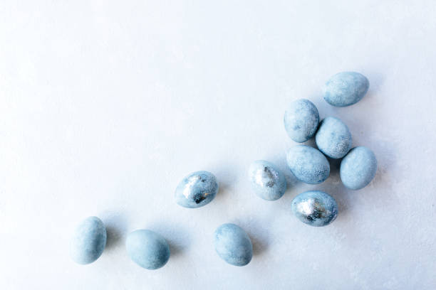istock Blue Colored Eggs and flowers on light background. Stylish minimal Compositions in pastel colors. Easter concept. Flat lay, top view. Copy space. 1209141195