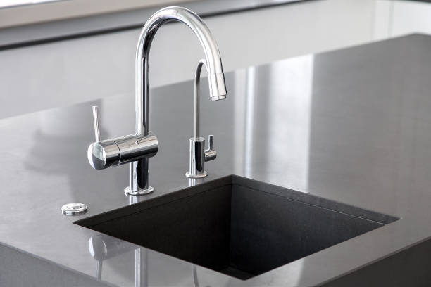 istock blank kitchen sink of dark gray marble with chrome tap in a clean kitchen with a glossy work surface, close up faucet sink with copy space. 1209141426