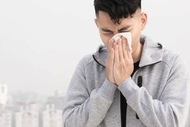 Photo of man has allergy and sneeze