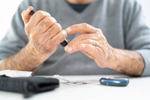 istock Hand detail senior doing diabetes test 1209143300