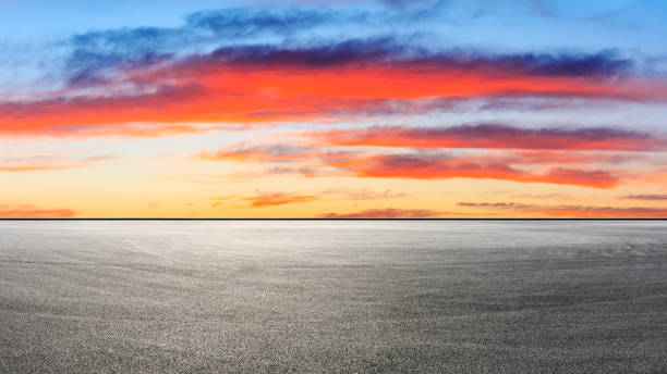 istock Empty race track and beautiful colorful clouds landscape at sunset. 1209144009