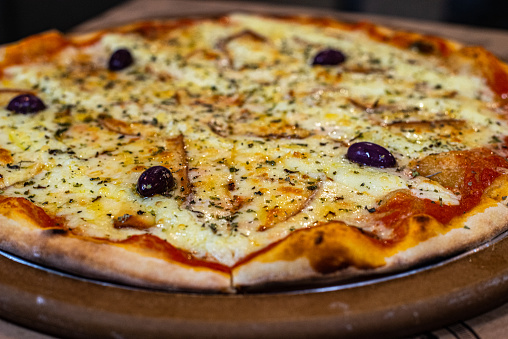 Pizza four cheeses : tomato sauce, mozzarella, parmesan, catupiry (creamy curd), provolone with black olives and oregano. In italy it is called : Quattro Formaggio