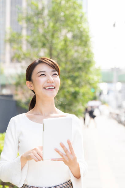istock asian woman to see a tablet computer 1209145282