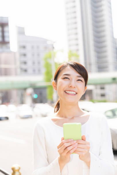 istock asian woman who see a smart phone 1209145302