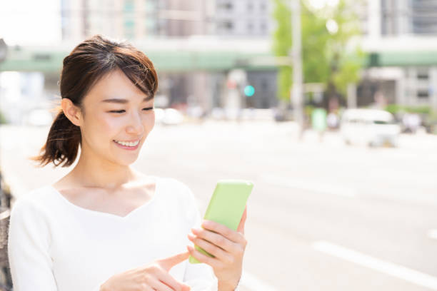 istock asian woman who see a smart phone 1209145869