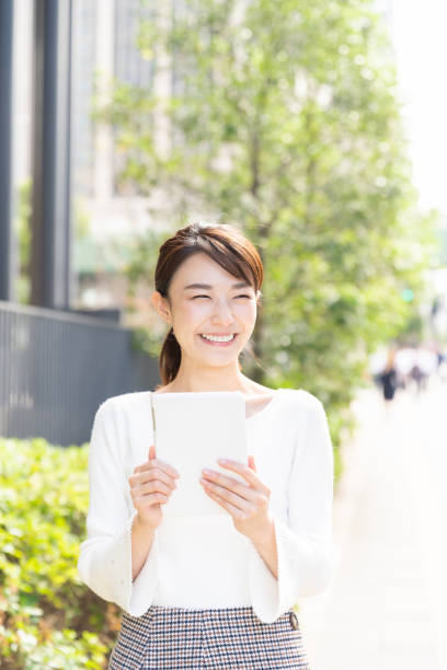 istock asian woman to see a tablet computer 1209145886