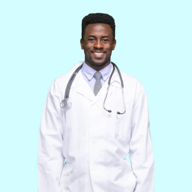 african-american ethnicity young male doctor in front of colored background wearing shirt - arms at side imagens e fotografias de stock