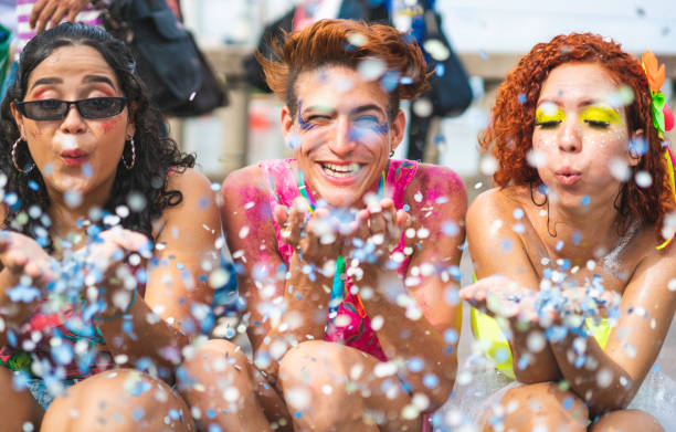 istock Friends blowing confetti at carnival 1209149784