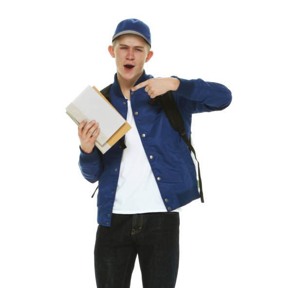 istock Caucasian male student in front of white background wearing backpack and holding textbook 1209151362